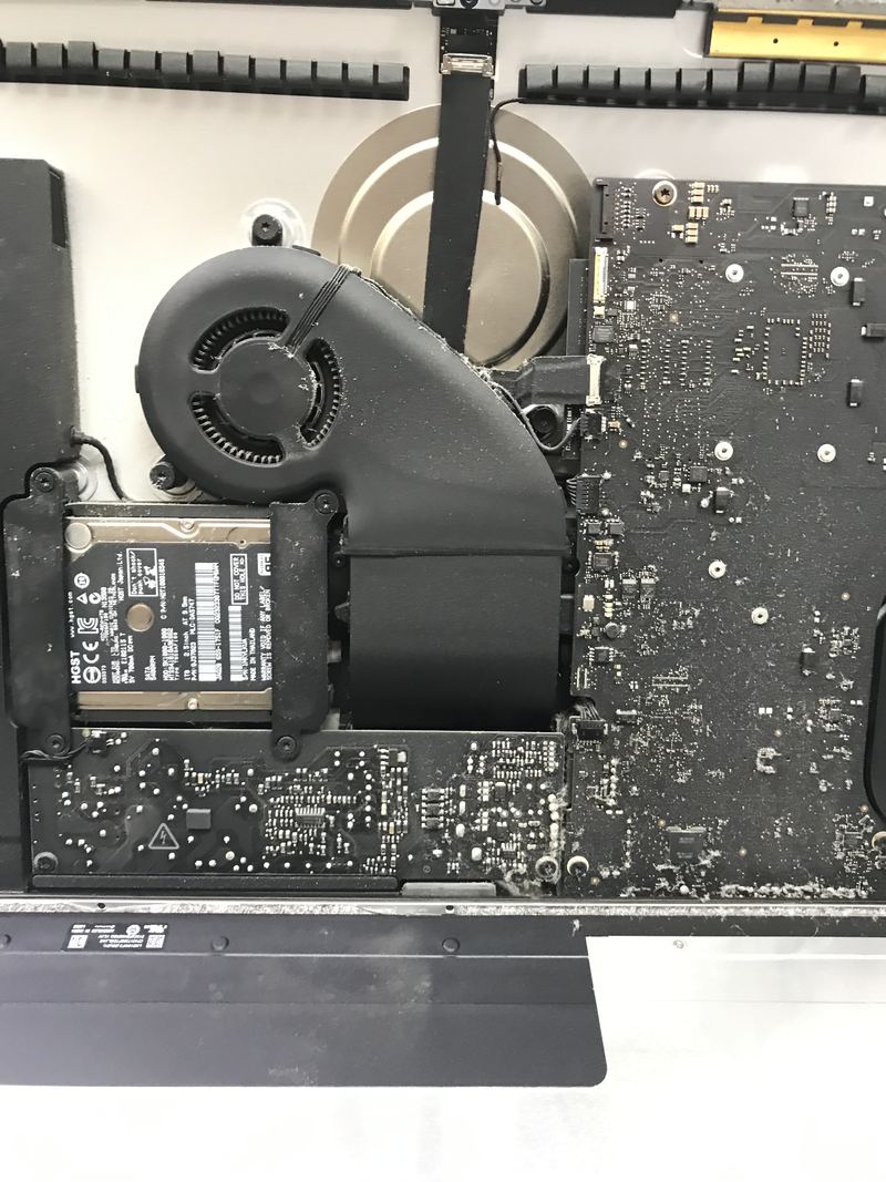 The inside of an opened Apple computer, showing the cooling fan and a 2.5-inch drive.
